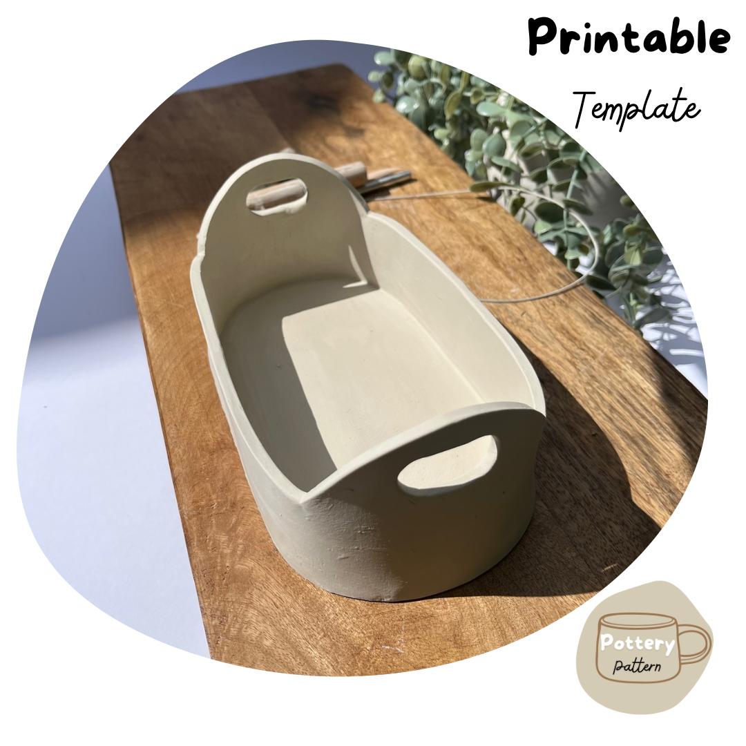 Handmade ceramic tray crafted using a printable pottery template, features built in handles and sleek, minimalist design. Displayed on a wooden surface with natural light, this template is ideal for creating a functional yet decorative pottery pieces. Perfect for beginners or pottery enthusiasts and DIY pottery projects.